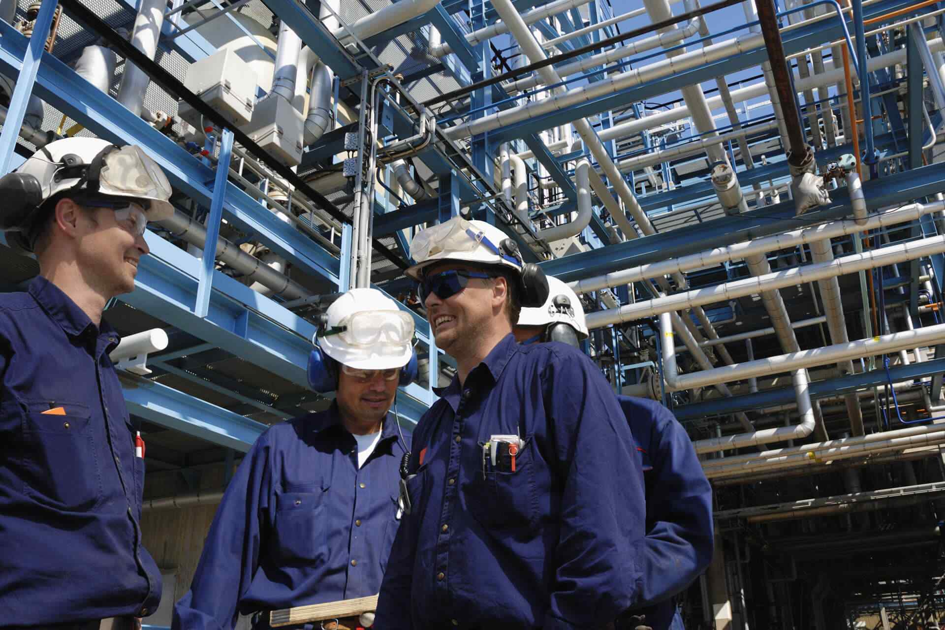 Workers standing at petrochemical plant
