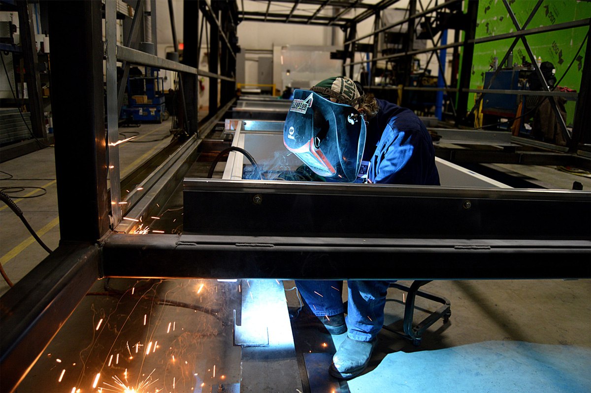 Welder is working on steel frame